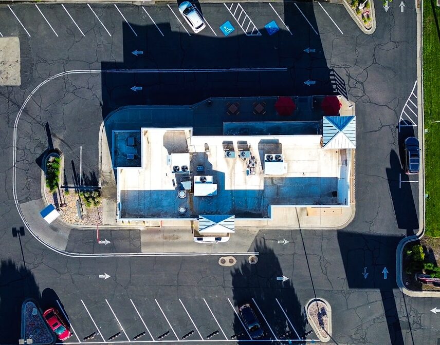 an aerial view of a parking lot with a gas station